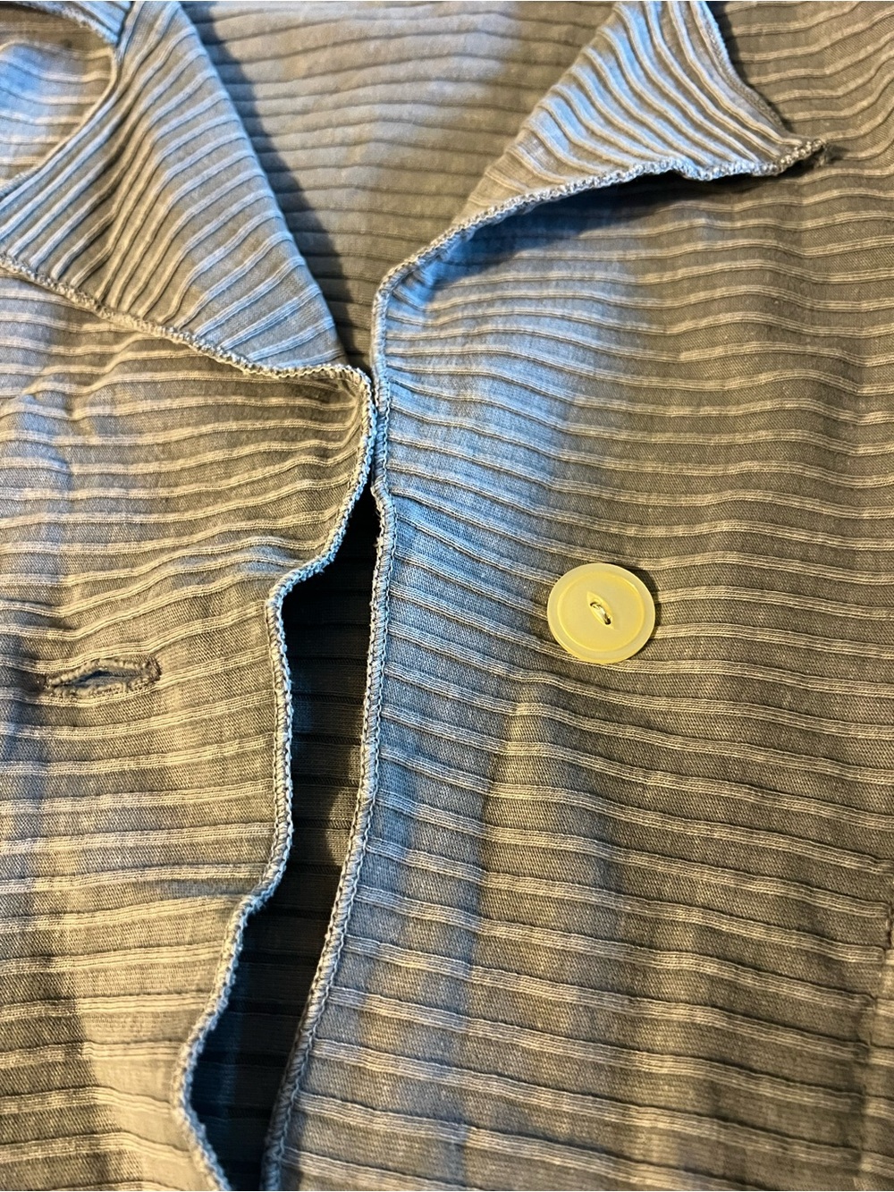Women’s light jacket with shiny white buttons. And front pockets.